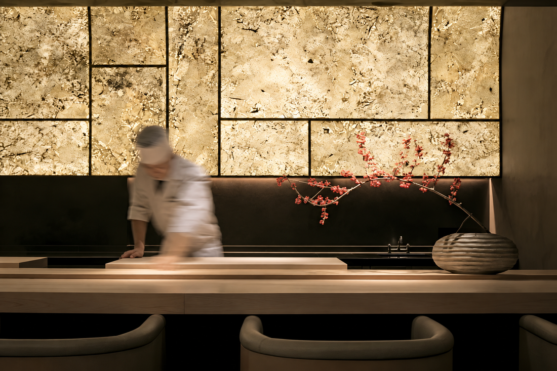 Translucent natural stone sheets used as a backlit feature wall in a modern kaiseki restaurant interior.