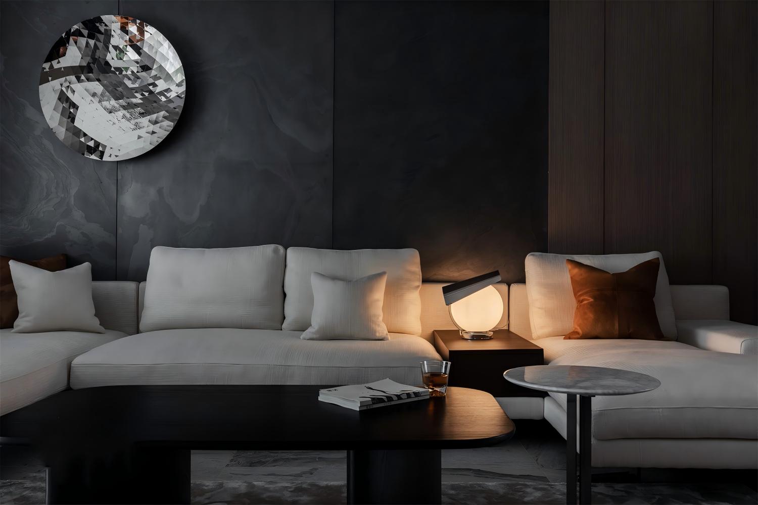 Black ultra-thin natural stone used as a modern living room feature wall with light sofa, warm lighting and refined interior design.