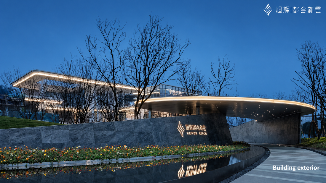 Silver Grey natural stone veneer used on a modern architectural entrance with curved exterior walls, water reflection and warm lighting.