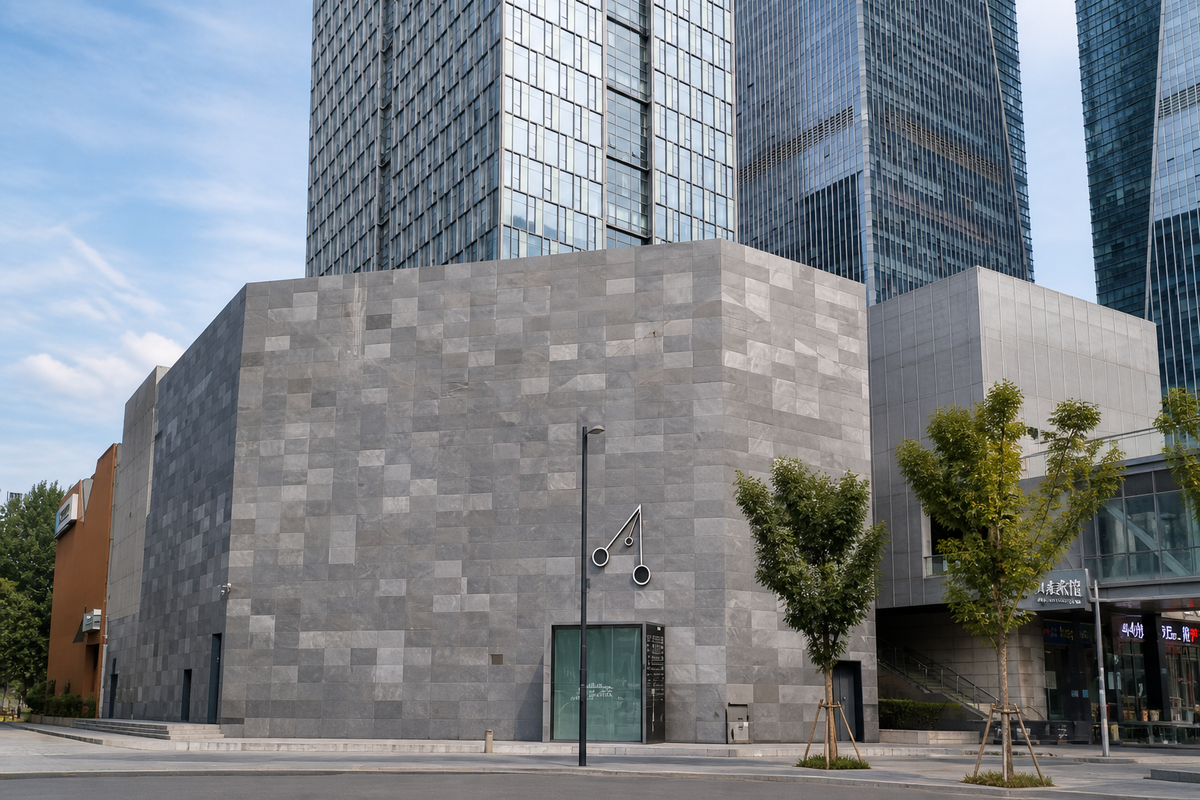 Galaxy Black natural stone veneer used on a modern commercial building facade with grey stone panels and urban architectural design.