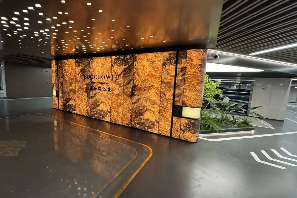 Translucent natural stone sheets used as a warm backlit stone feature wall in a commercial interior space.