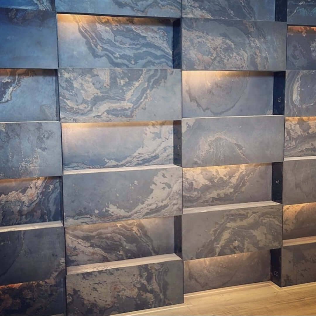 Interior stone veneer feature wall with blue-gray panels and beige streaks in grid