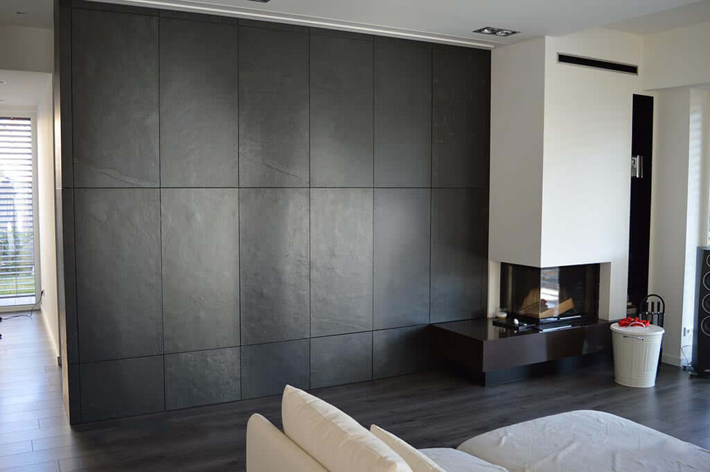 Black natural stone veneer feature wall with rectangular panel layout and gray tones