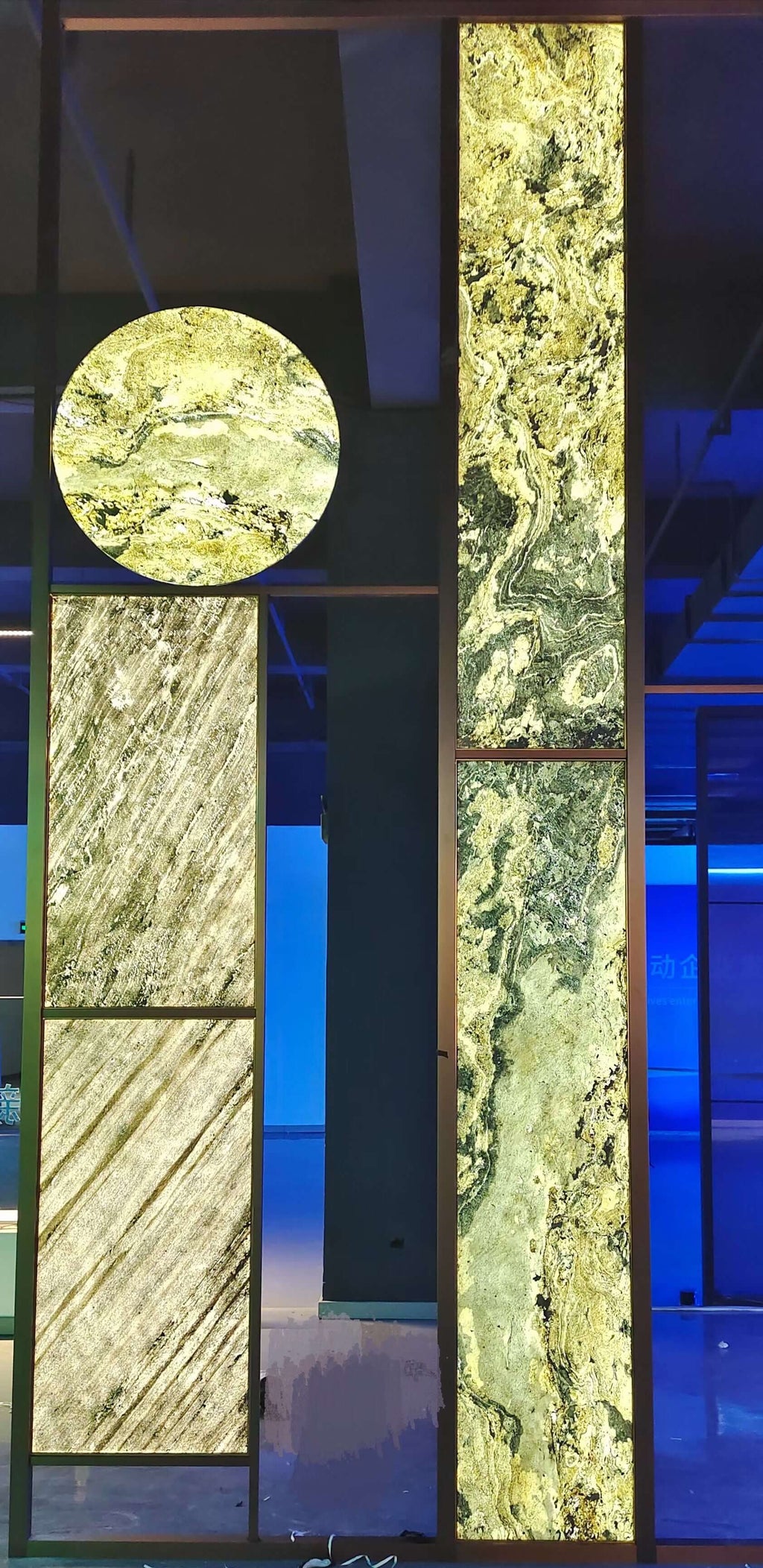 Translucent natural stone sheet panels in light green with veined texture
