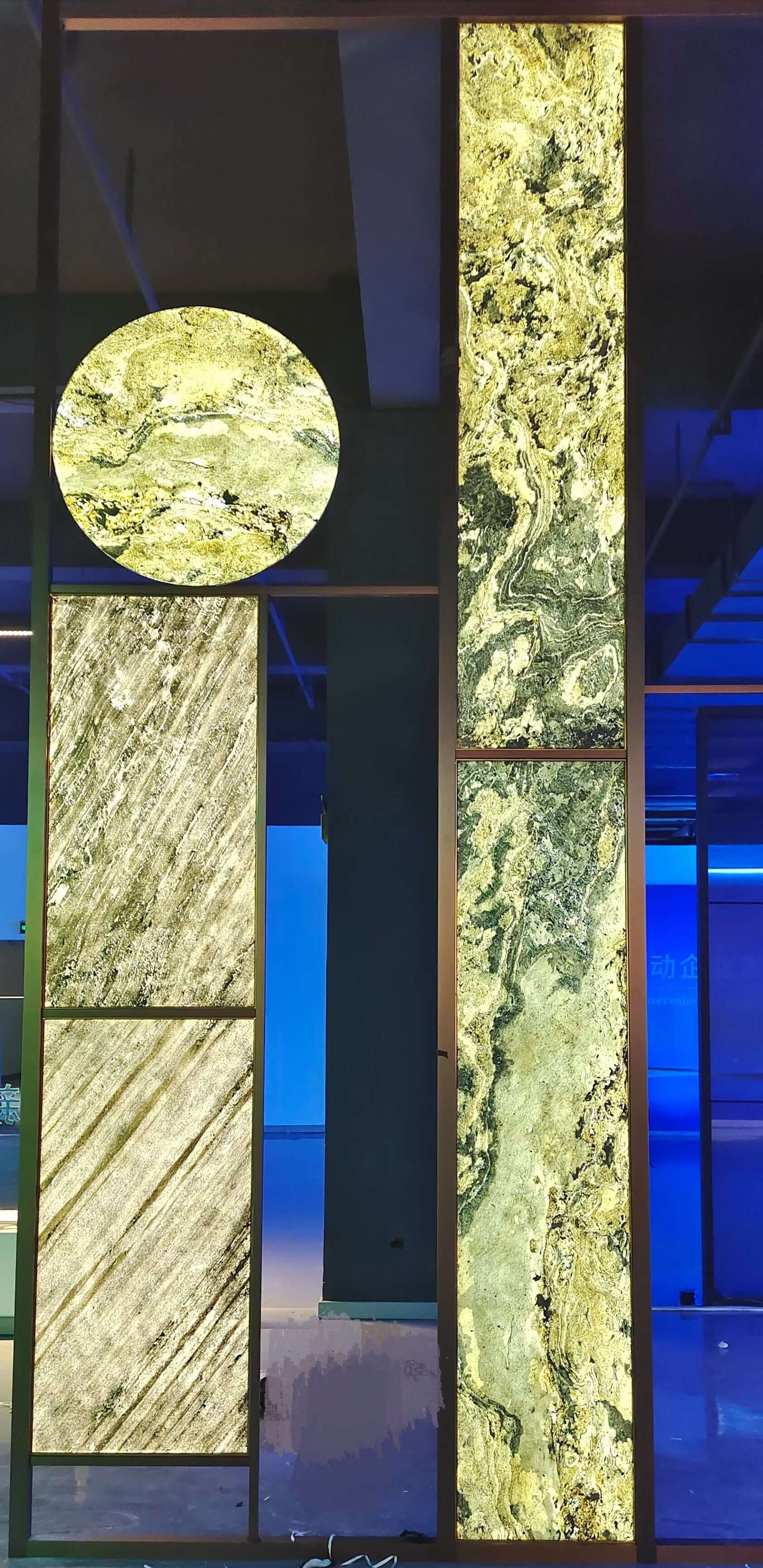Translucent natural stone sheet panels in light green with veined texture