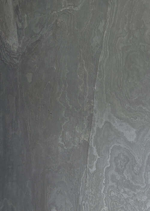 Black natural stone veneer panels with gray veining and mottled texture