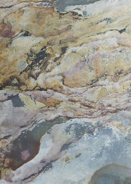 Natural stone veneer sheet with mottled cream, tan, and gray veining