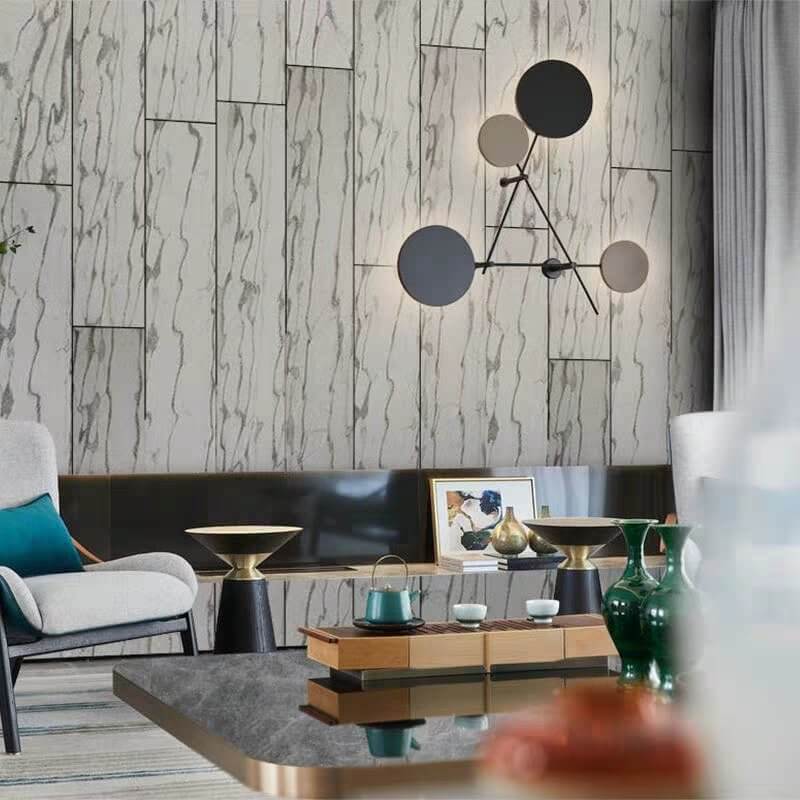Stone veneer wall cladding with white-gray marble veining in an interior setting