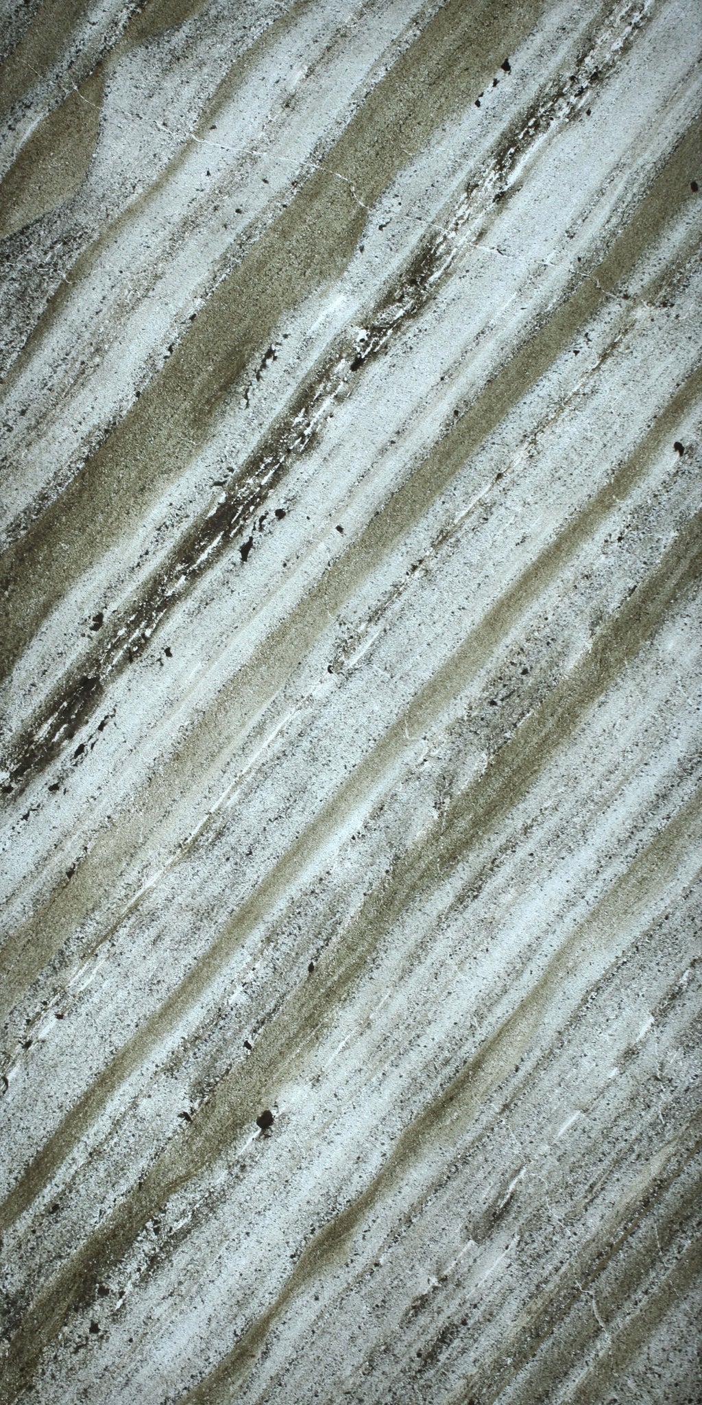 Close-up translucent natural stone sheet with pale gray and speckled lines