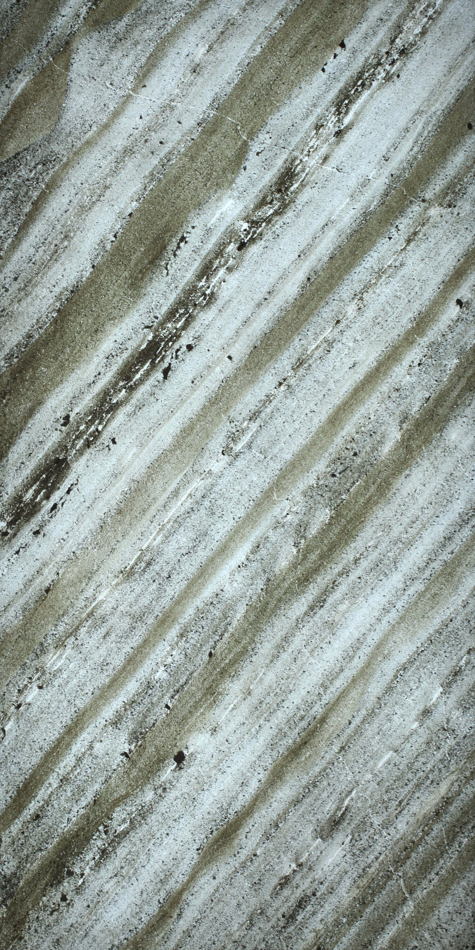 Close-up translucent natural stone sheet with pale gray and speckled lines