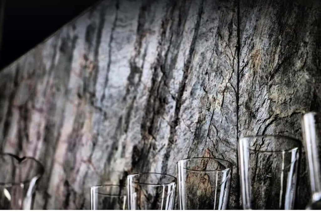 Close-up of blue-gray stone veneer with faint copper highlights and natural striations