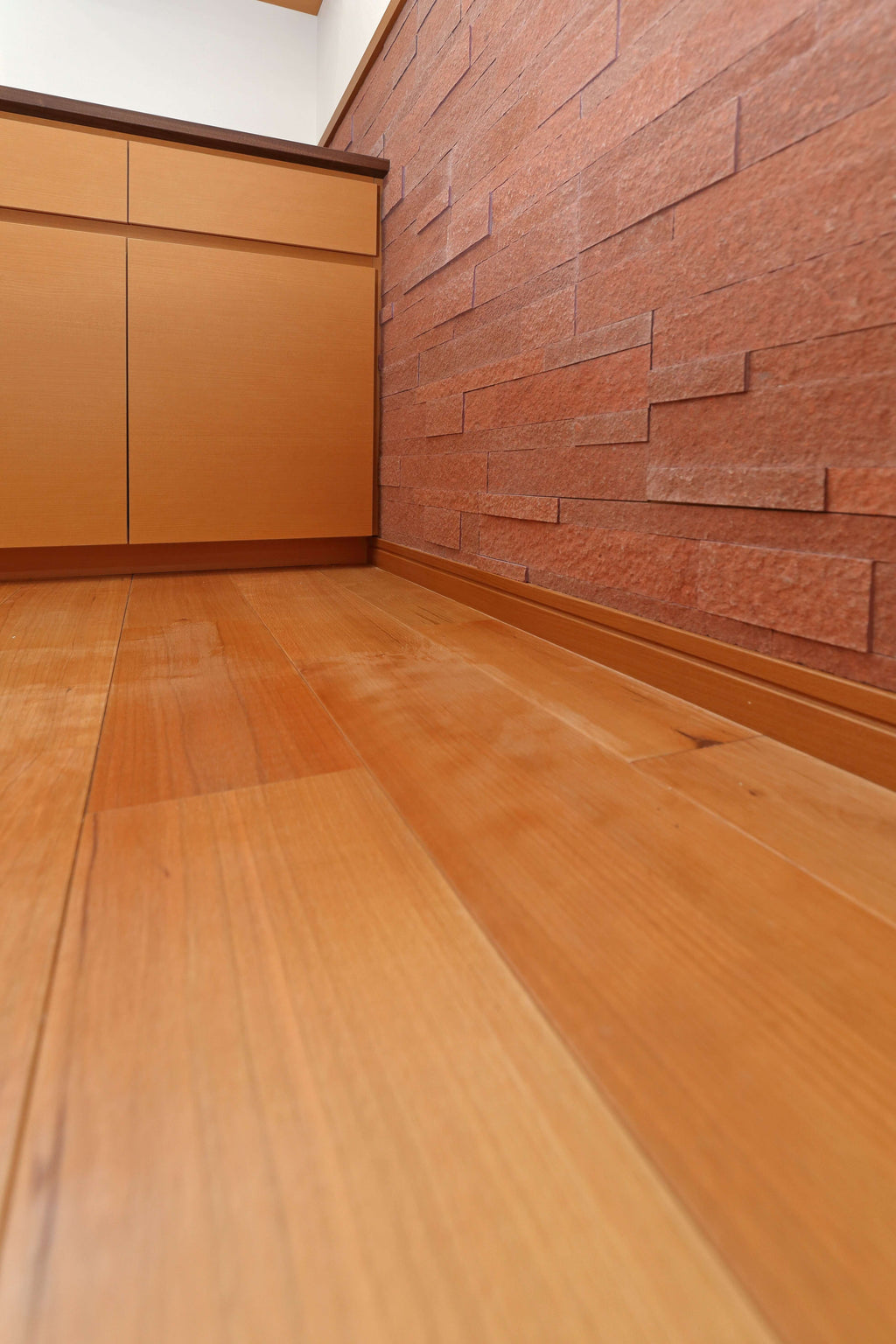 3D Terra Red peel and stick stone veneer used for interior wall corner application with natural stone texture