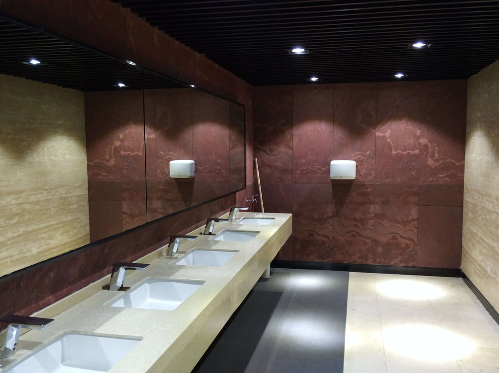 Terra red natural stone veneer bathroom wall with mottled swirl patterns