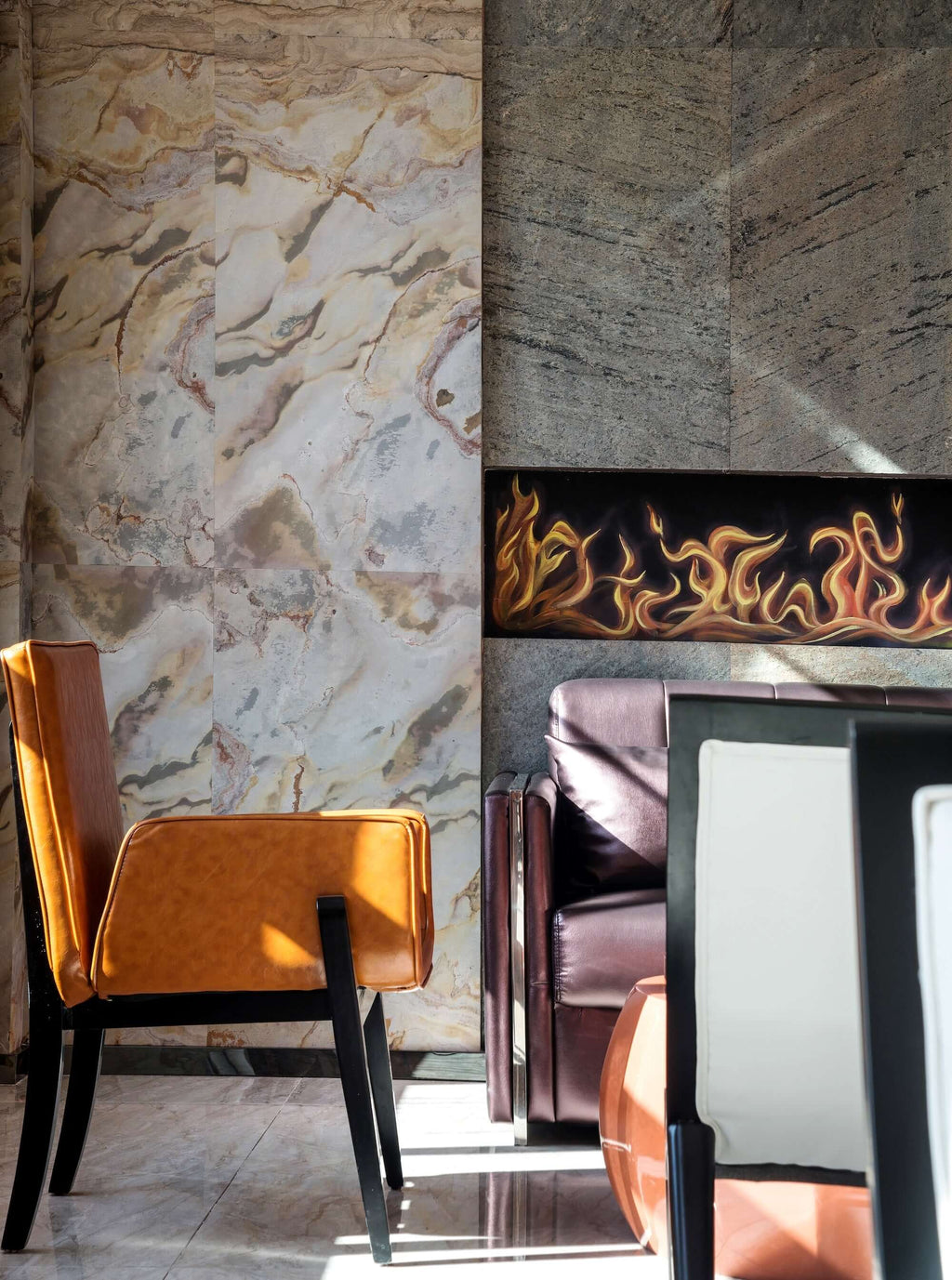 Stone veneer wall surfaces with cream, gray, and brown swirled patterns