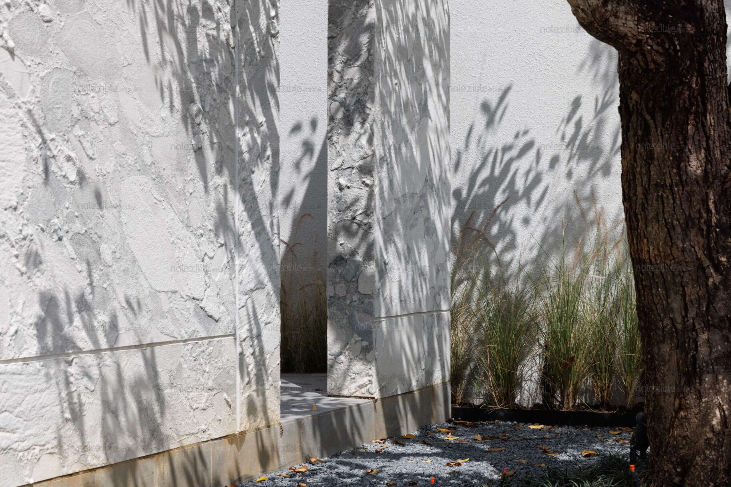 Granite stone veneer wall panels in light gray with textured veining and visible seams.