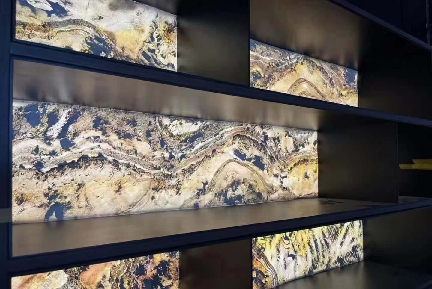 Stacked stone wall panels with blue-gray and beige marbled swirls