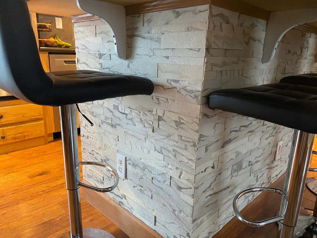 3D Arctic-Storm Peel & Stick Stone installed on a kitchen island wall with textured natural stone surface