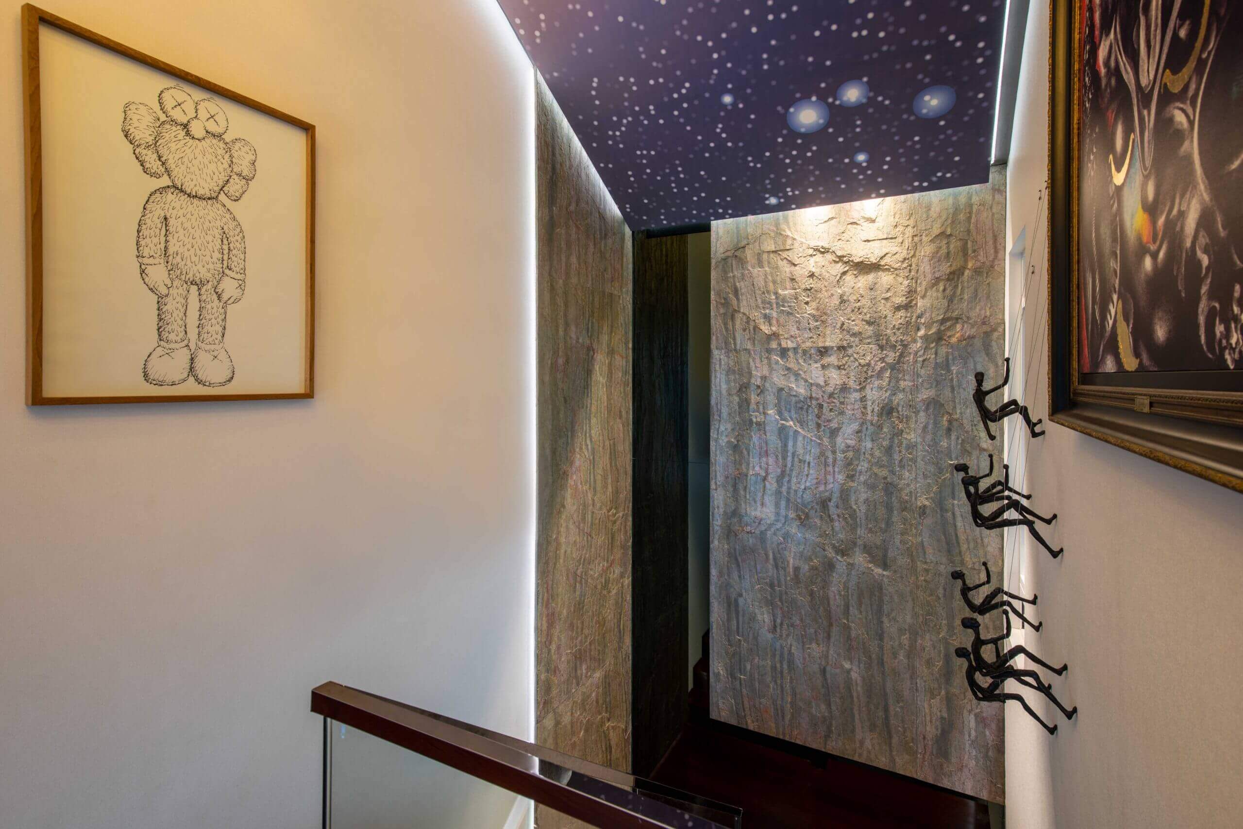 Interior accent wall clad with blue-gray natural stone veneer, featuring copper-brown lines