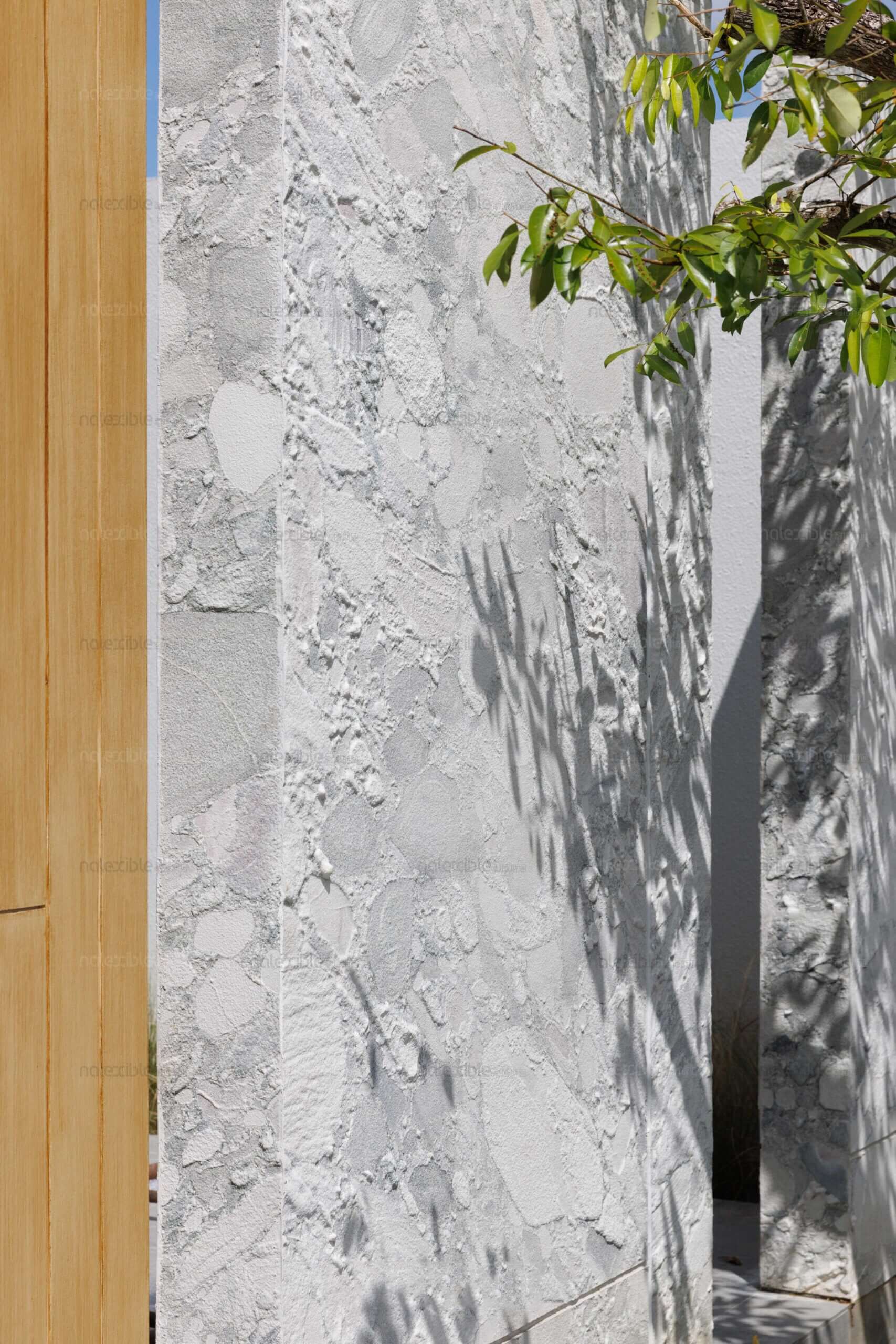 Granite stone veneer panel in light gray with mottled speckle and natural crack-like veins.