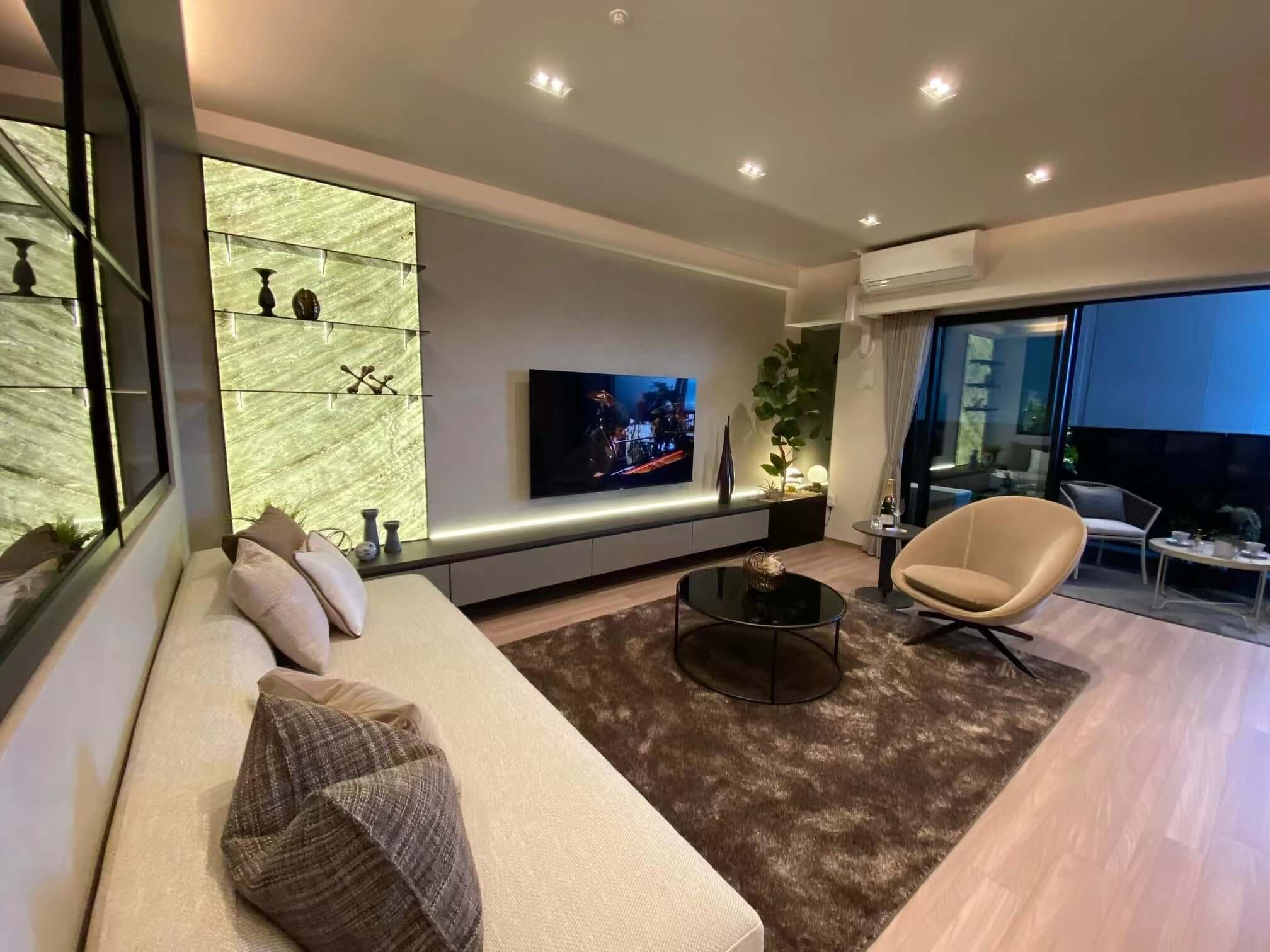 Vertical stone wall panels with green marble veining behind modern living room seating