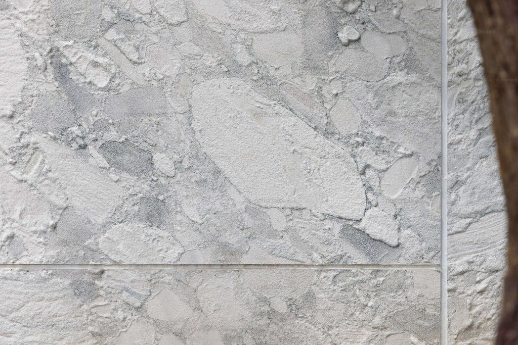 Light gray granite stone veneer with horizontal seam lines and mottled natural texture.