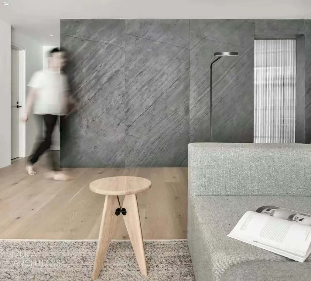 D.Black natural stone veneer accent wall, medium gray texture with etched vein lines