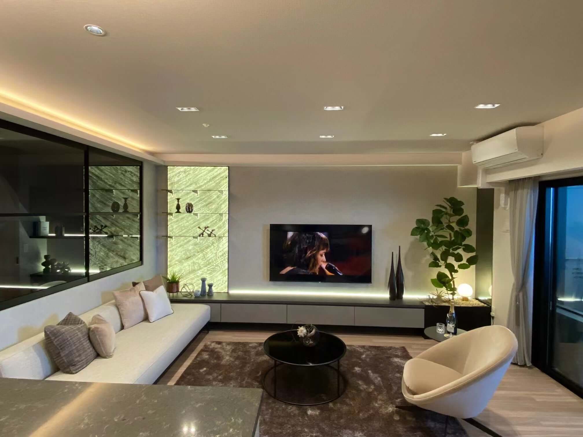 Stone wall panels with green marble veining, TV wall section in modern living room
