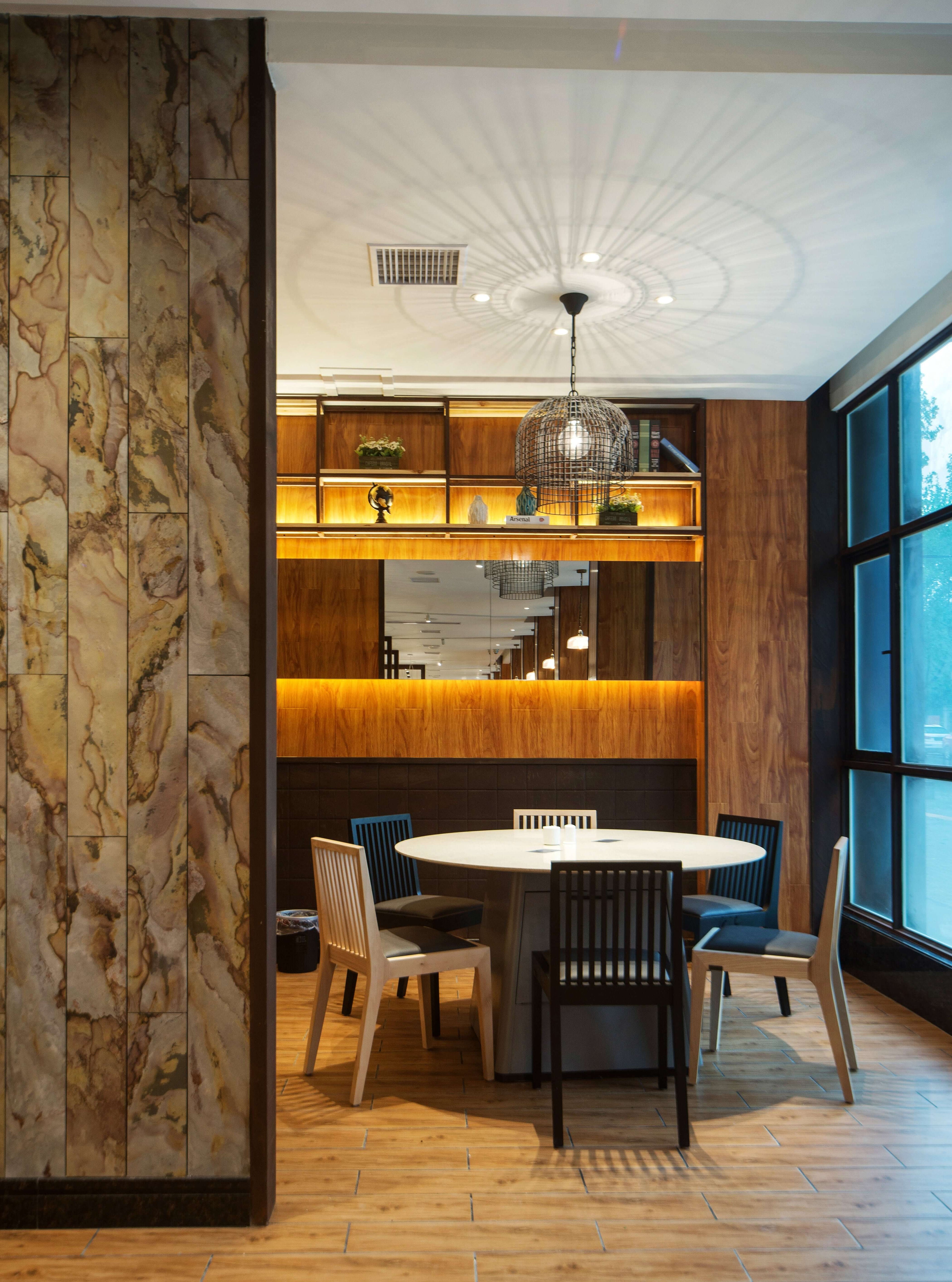 Natural stone veneer feature wall with tan, olive, and gold veining
