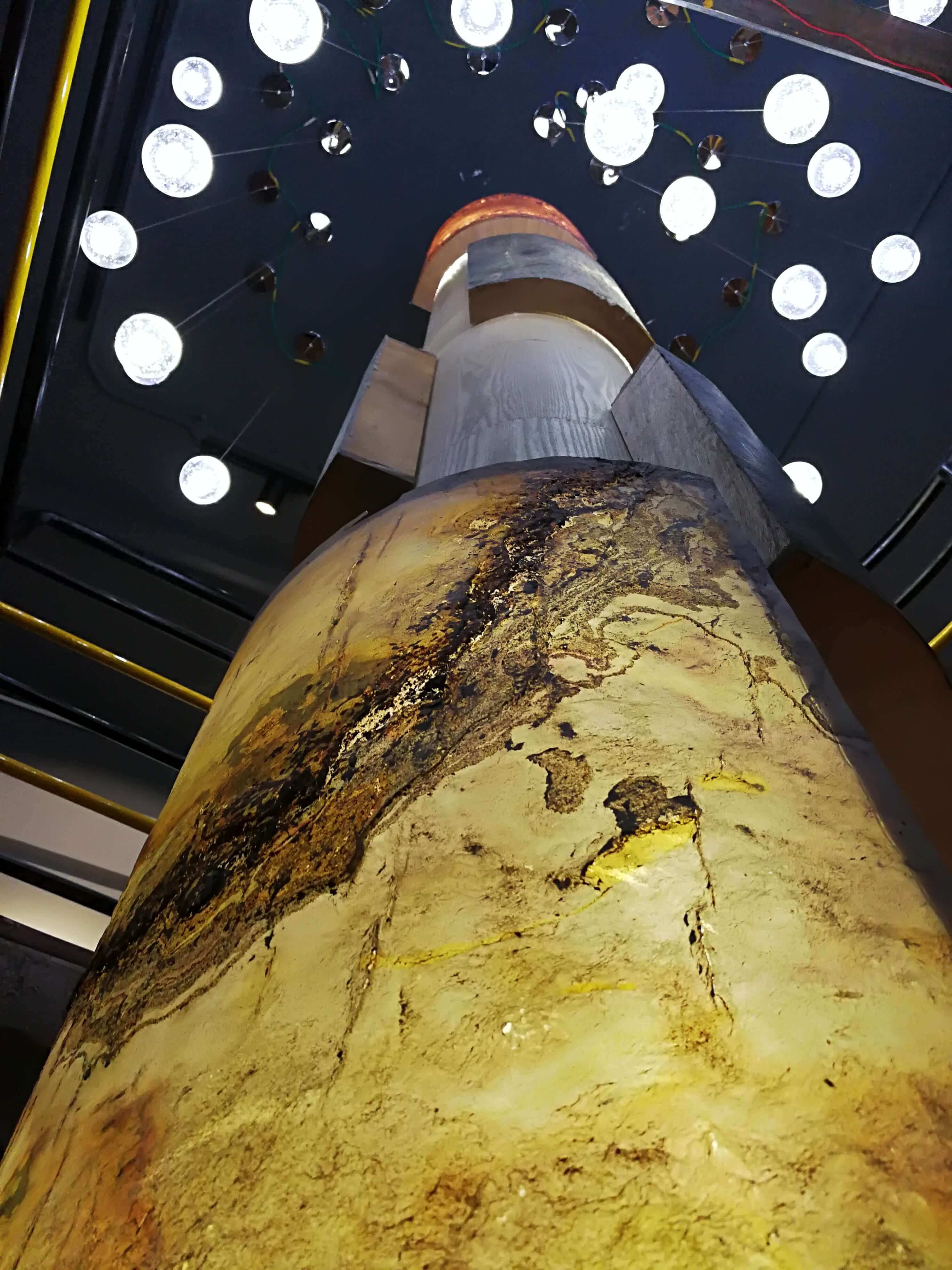 Cylindrical translucent stone surface with gold and brown mottled natural texture