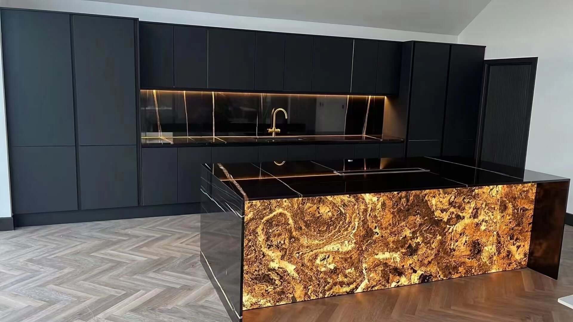 Terra red natural stone counter splash panel with warm gold veining, wide view