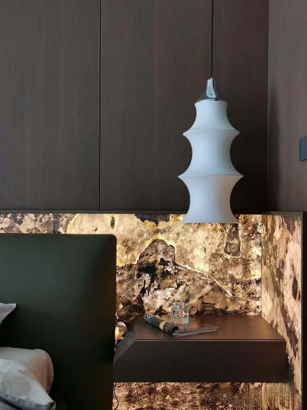 Stone fireplace wall niche with dark base and beige veined stone surface
