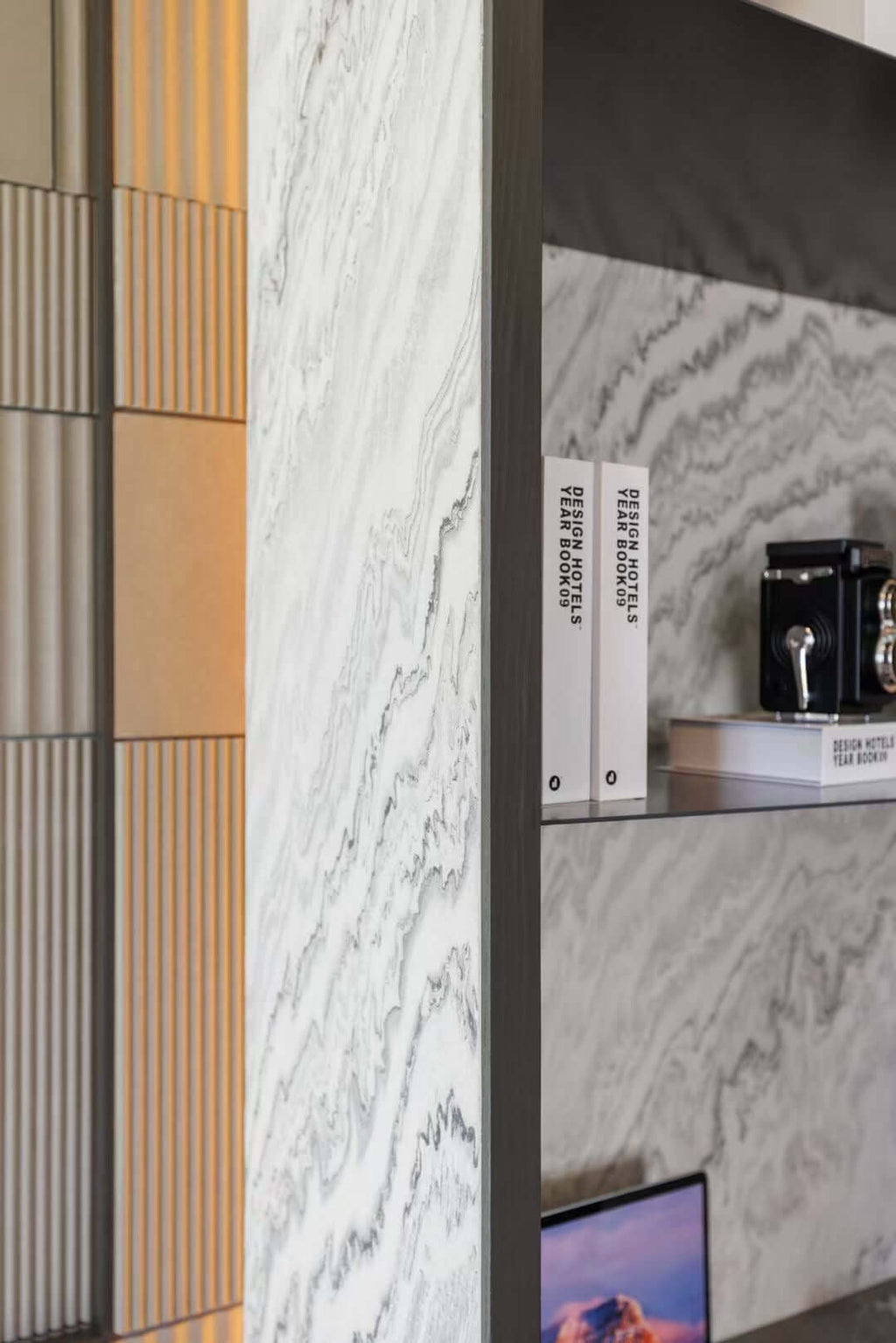 Stone veneer samples showing white-gray veining next to vertical wood slat accents