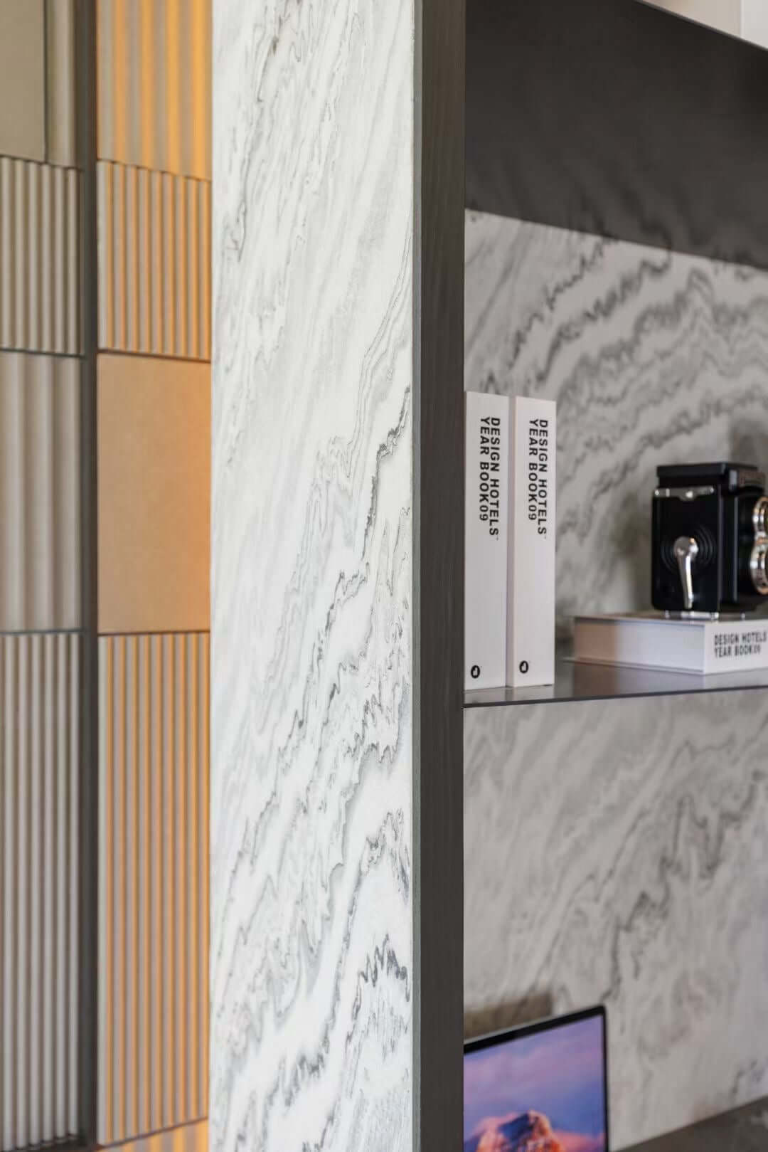 Stone veneer samples showing white-gray veining next to vertical wood slat accents