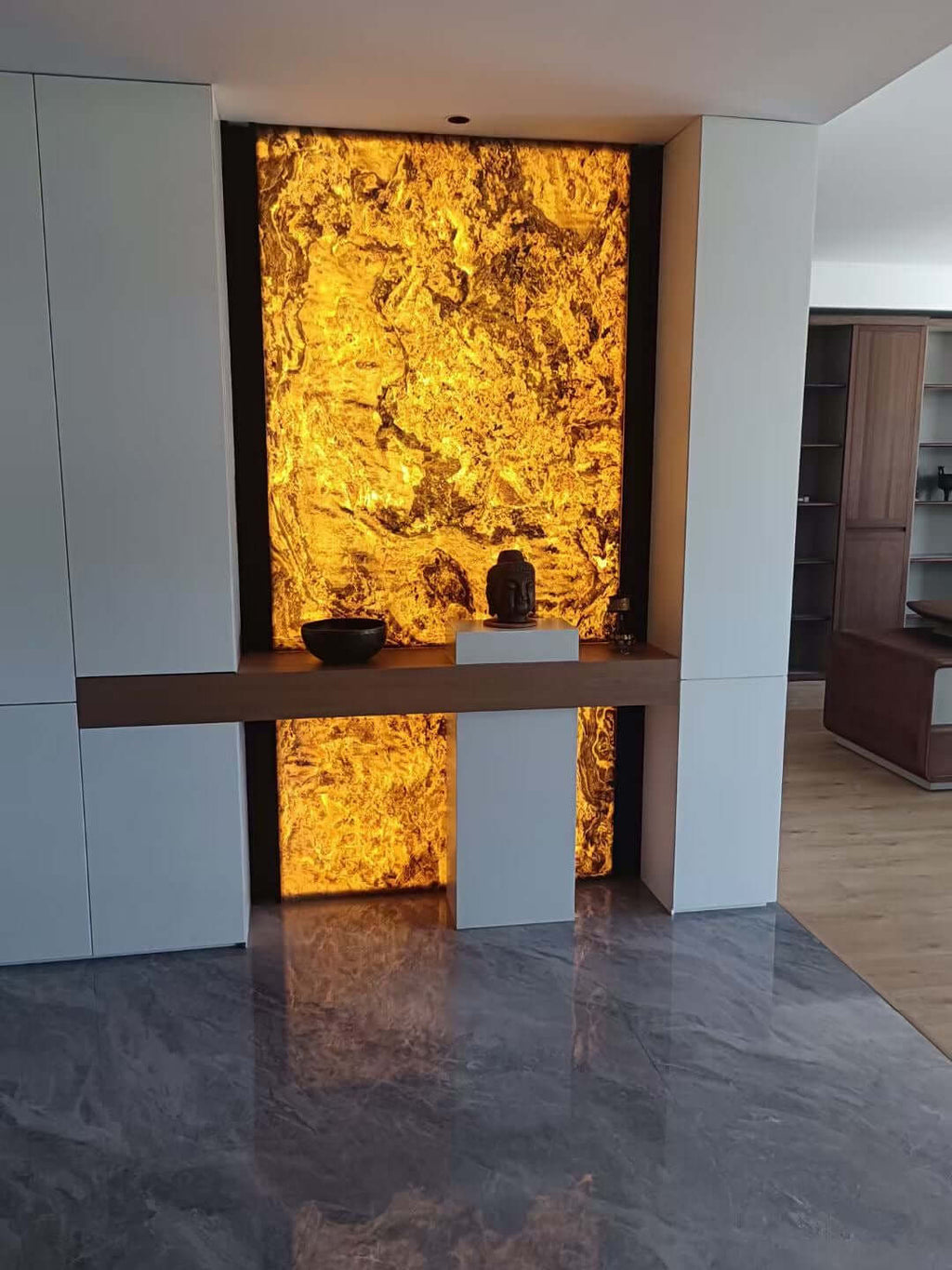 Abstract textured wall panel with glowing gold center and gray side surfaces