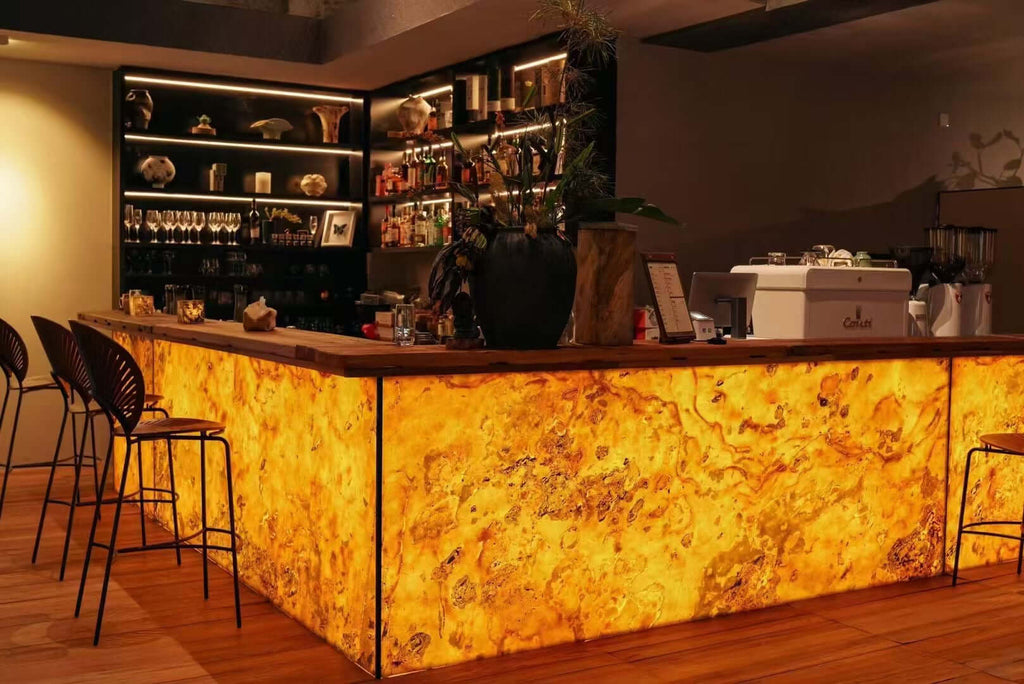 Gold translucent stone bar front paneling with warm marbled stone texture