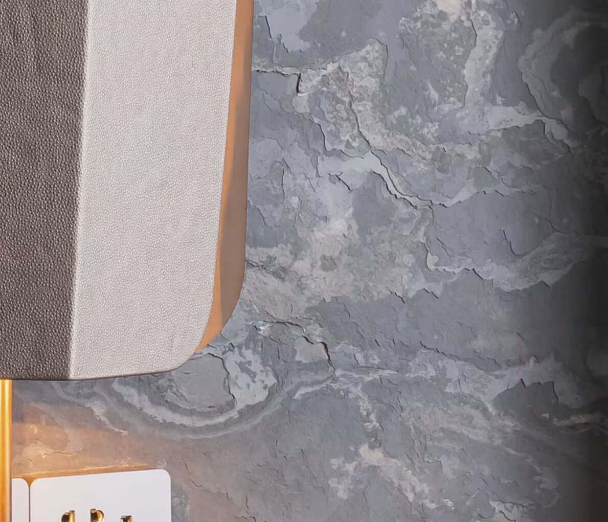 Stone veneer corner detail with gray-blue veining and light beige patches