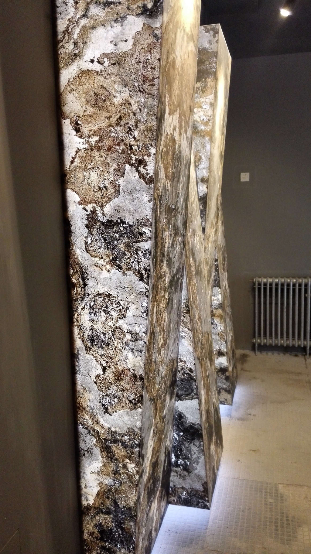 Textured stone slab sheet with white, beige, and dark speckled marbling