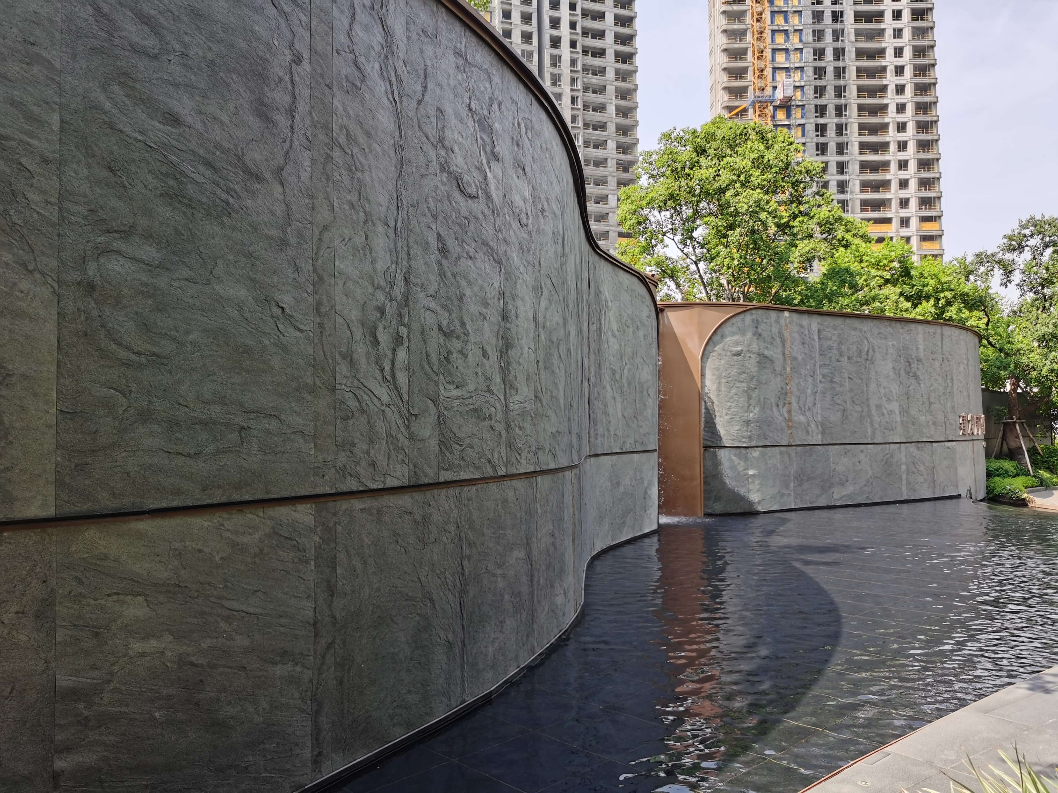 Silver grey natural stone veneer wall with smooth curved edges and textured face