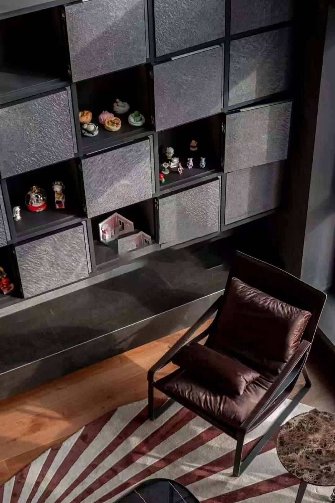 Black stone veneer wall with square niches and shelves