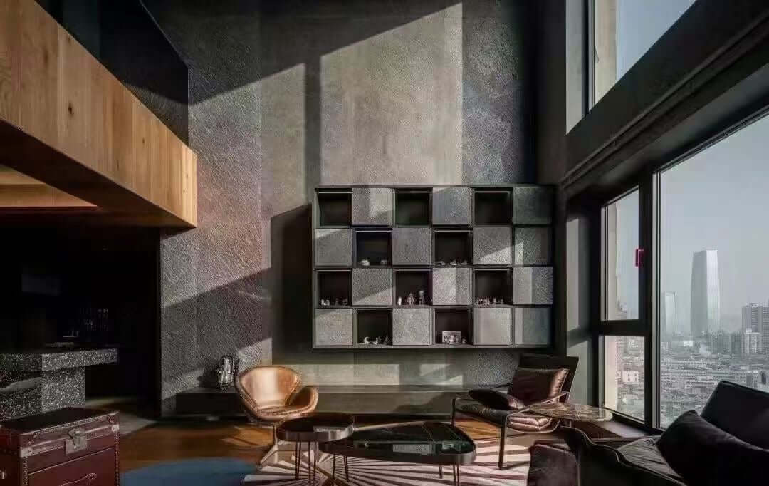 Black stone veneer wall with stacked square panels in a grid layout