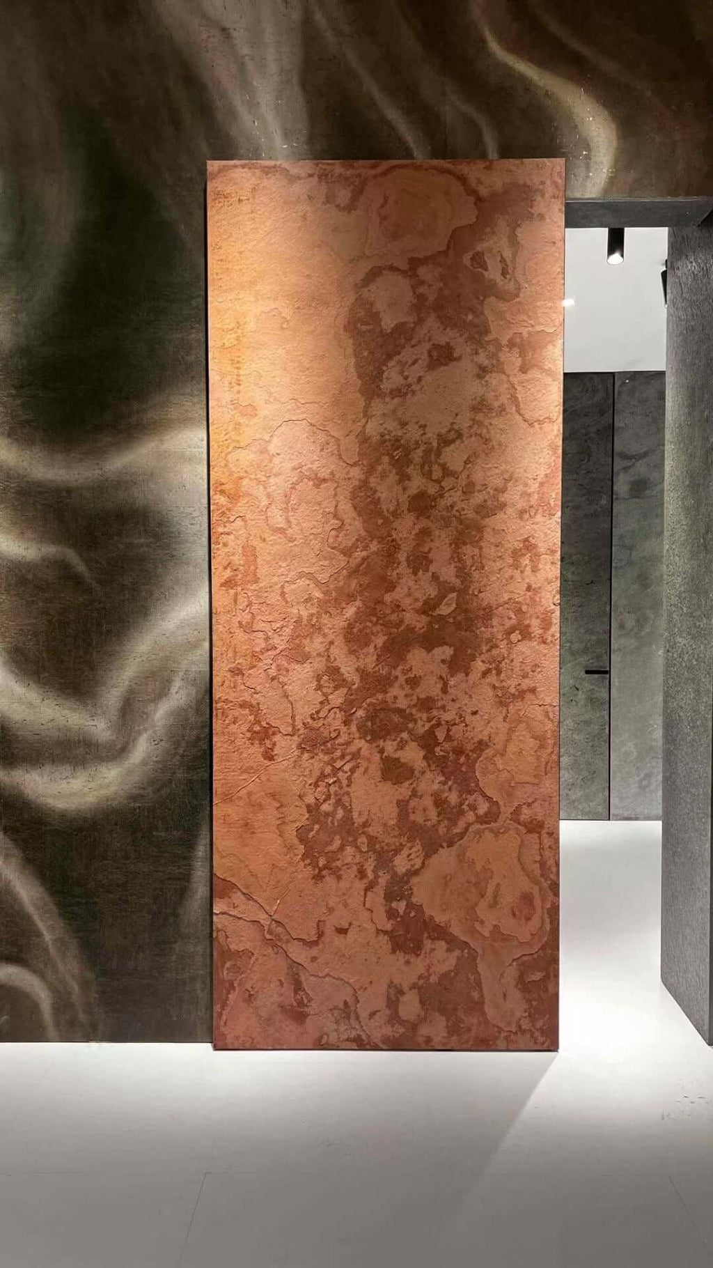 Terra red natural stone veneer slab with variegated swirl patterns