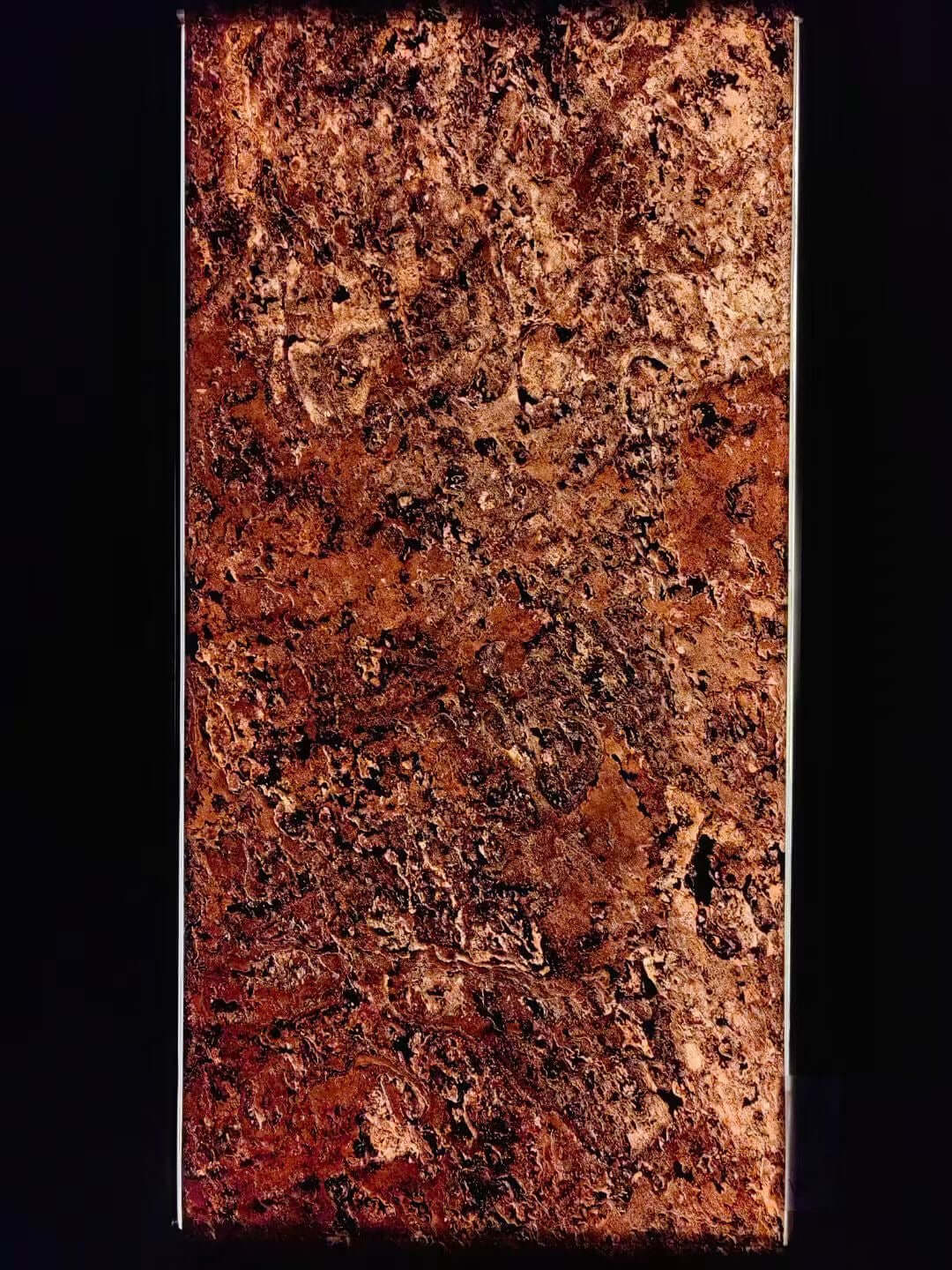 Textured red stone wall panel close-up with speckled, mottled surface