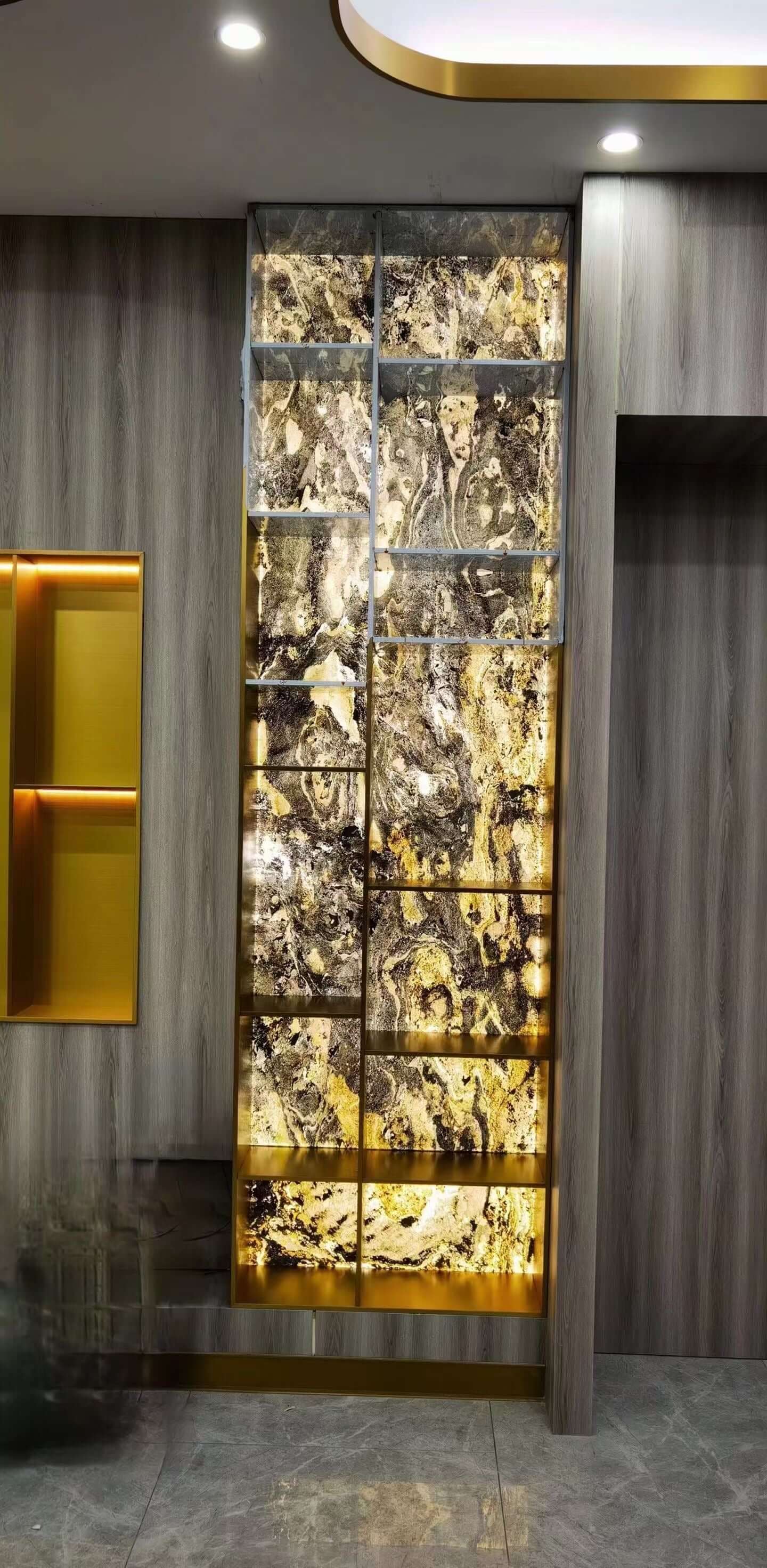 Tall wall panel with gold-and-black marbled stone blocks in dark frame