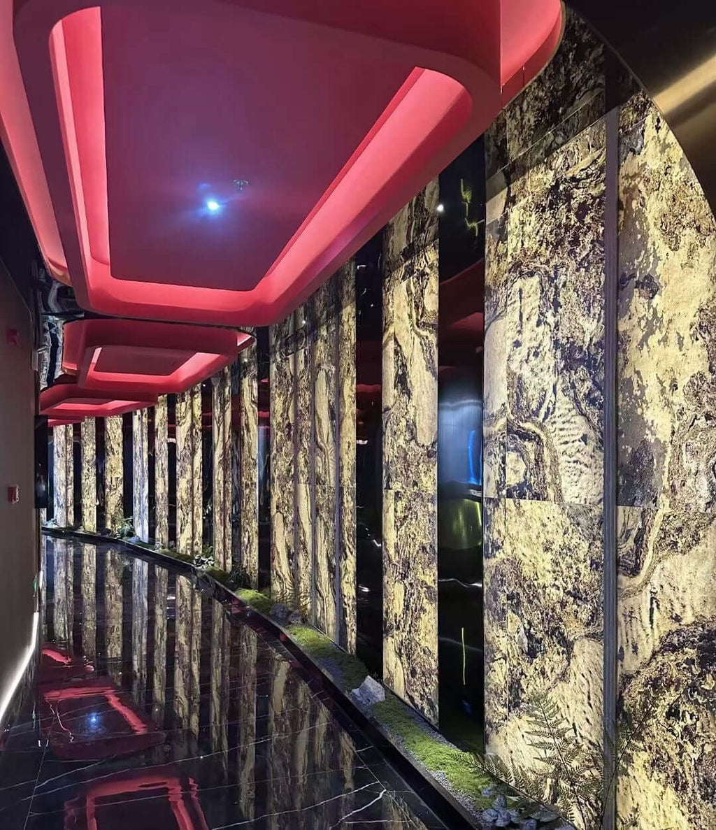 Long corridor walls covered in gold-veined dark stone sheets with vertical trim