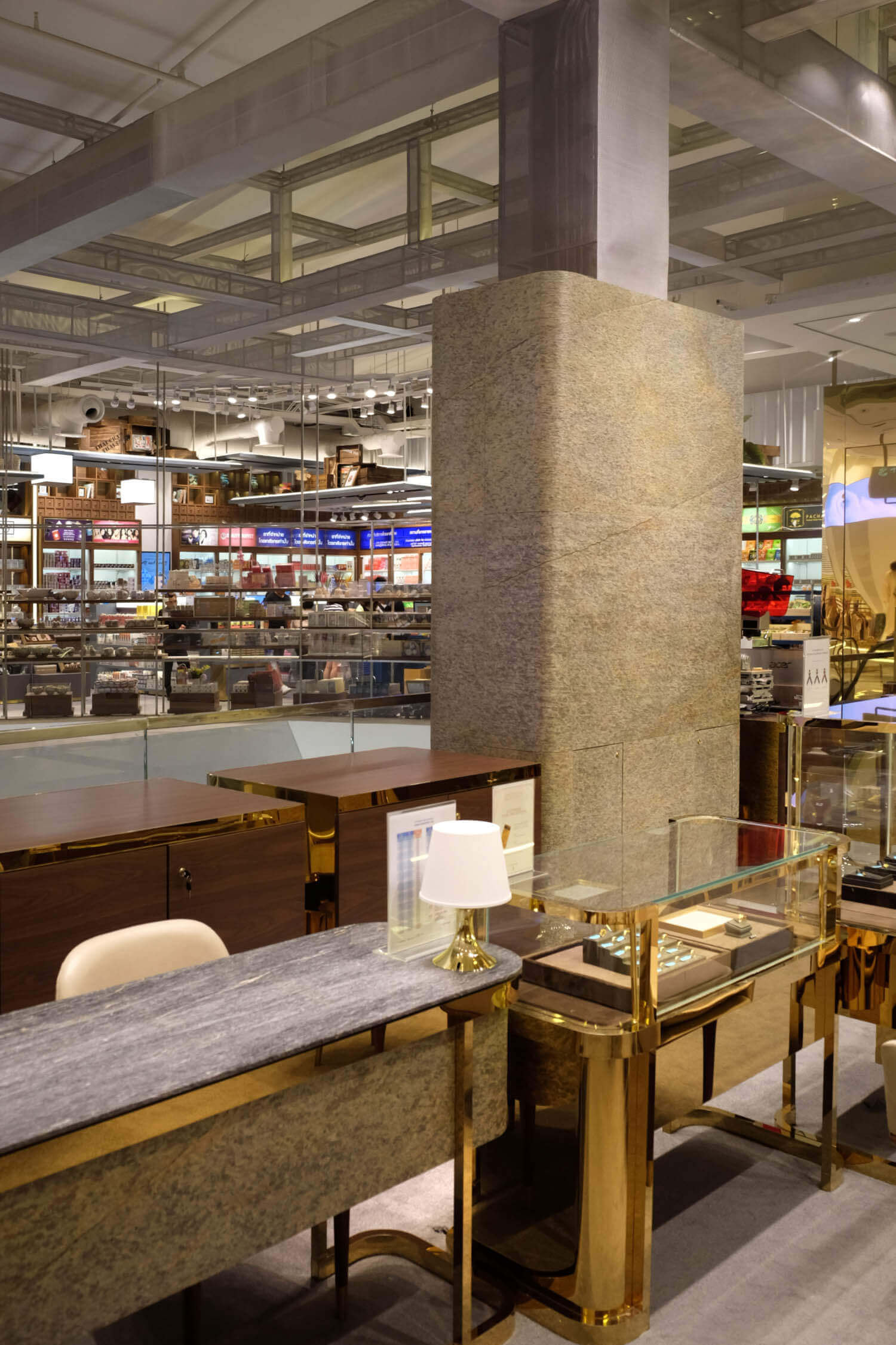 Gray and gold natural stone veneer column and countertop surfaces with speckled texture