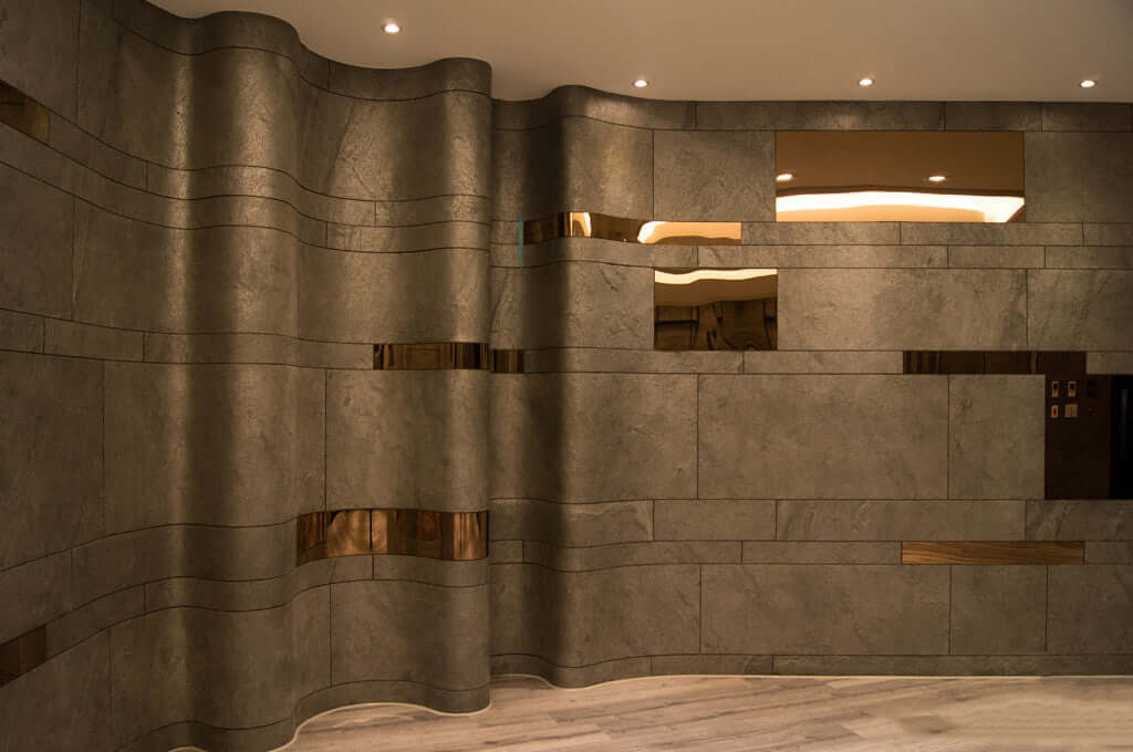 Silver grey natural stone veneer wall panels with wavy stacked block pattern