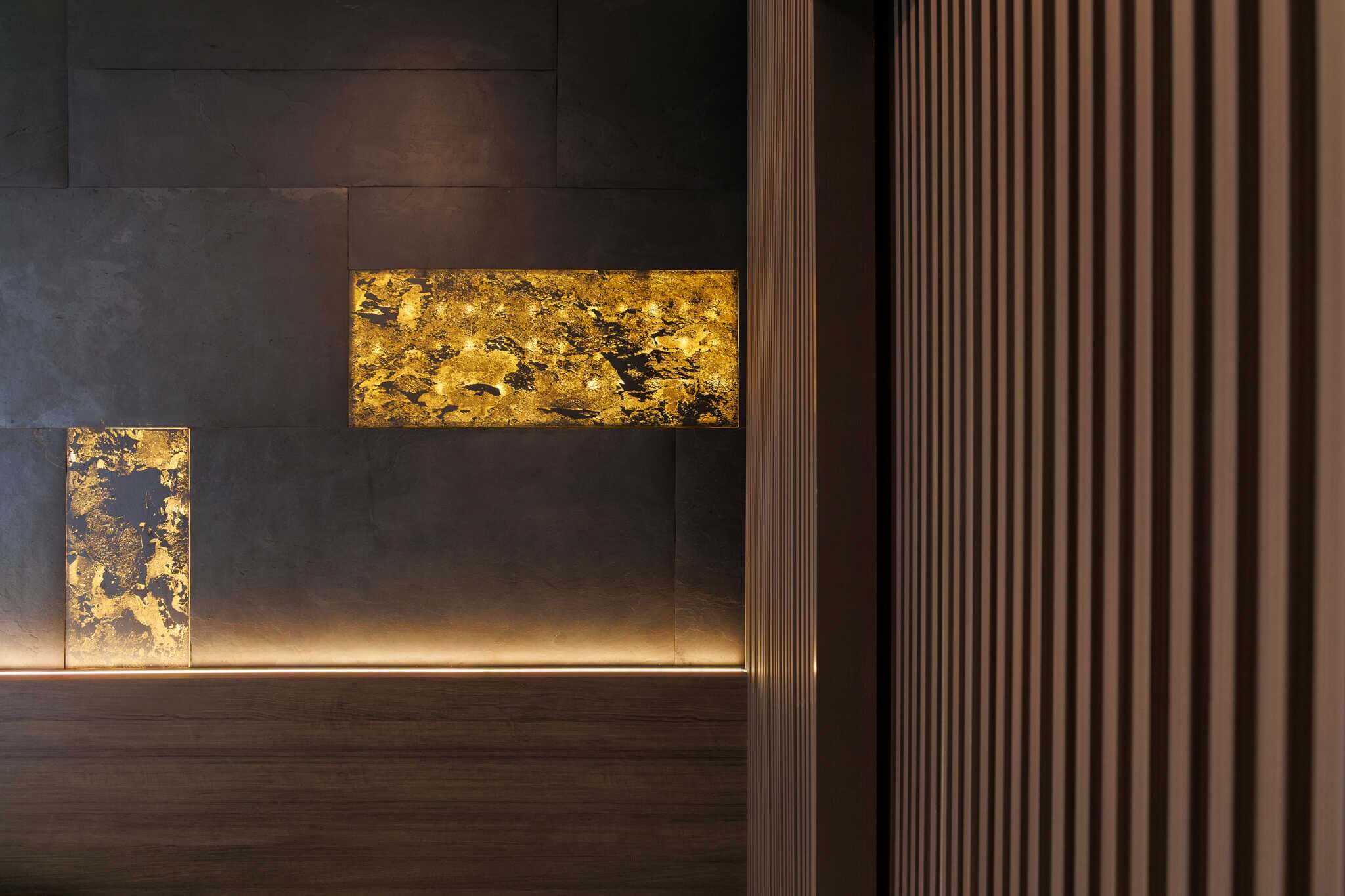 Translucent natural stone sheet wall inset with mottled gray texture and gold-toned glow