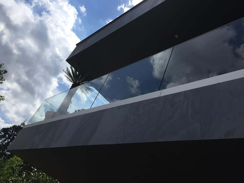 Black stone veneer facade with dark panel surfaces and light gray stone lines