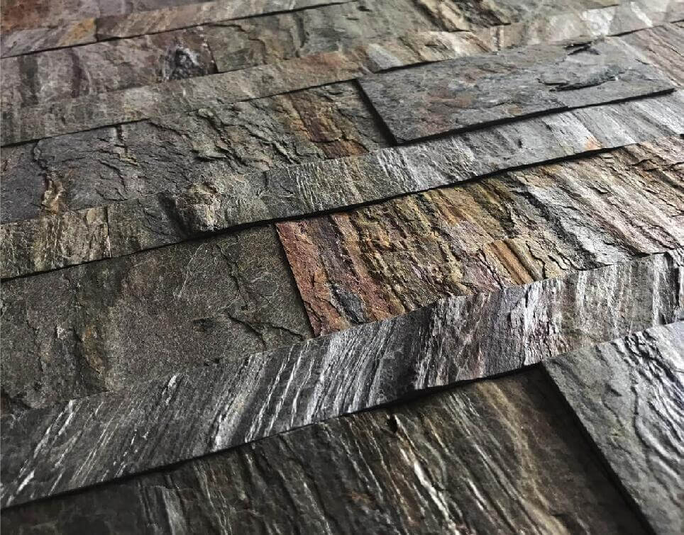 Peel-and-stick stone wall tile sheet, close-up of mottled gray and copper streaks