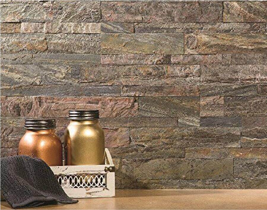 Peel-and-stick stone wall tile backdrop with weathered gray, tan, and copper flecks